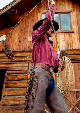 A Siwash Lake wrangler practices his roping skills at the barn